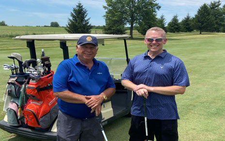 Two men in polo shirts standing